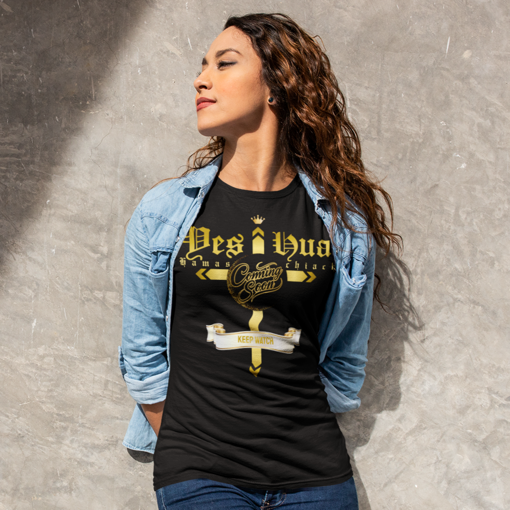 Woman wearing a black t-shirt with graphic design against a textured wall
