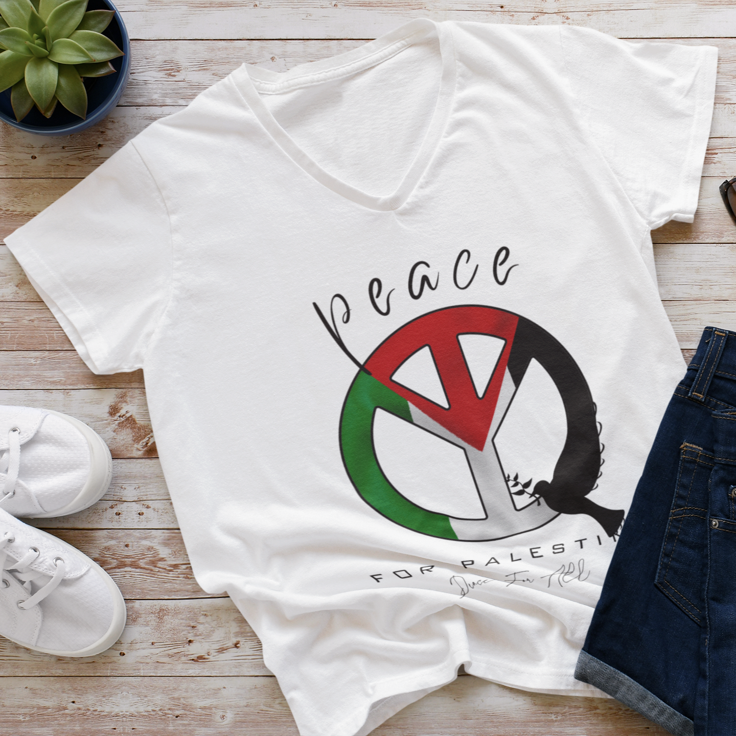 White t-shirt with 'Peace for Palestine' design on a wooden surface with shoes and sunglasses.