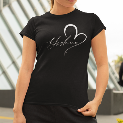 Woman wearing a black t-shirt with 'Yeshua' design outdoors.