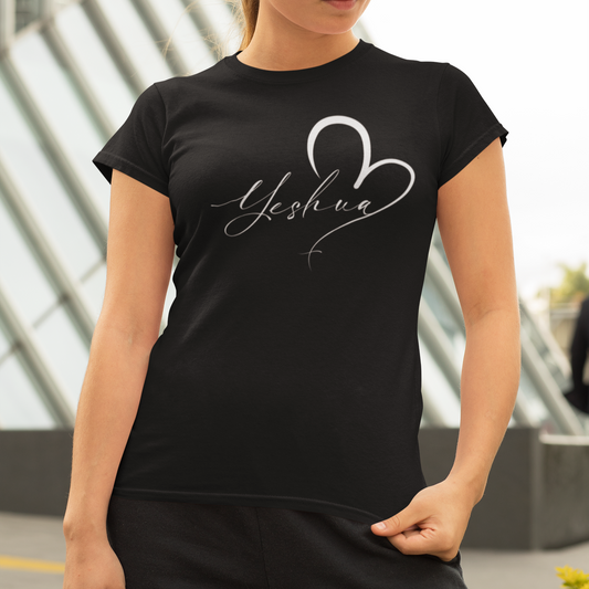 Woman wearing a black t-shirt with 'Yeshua' design outdoors.