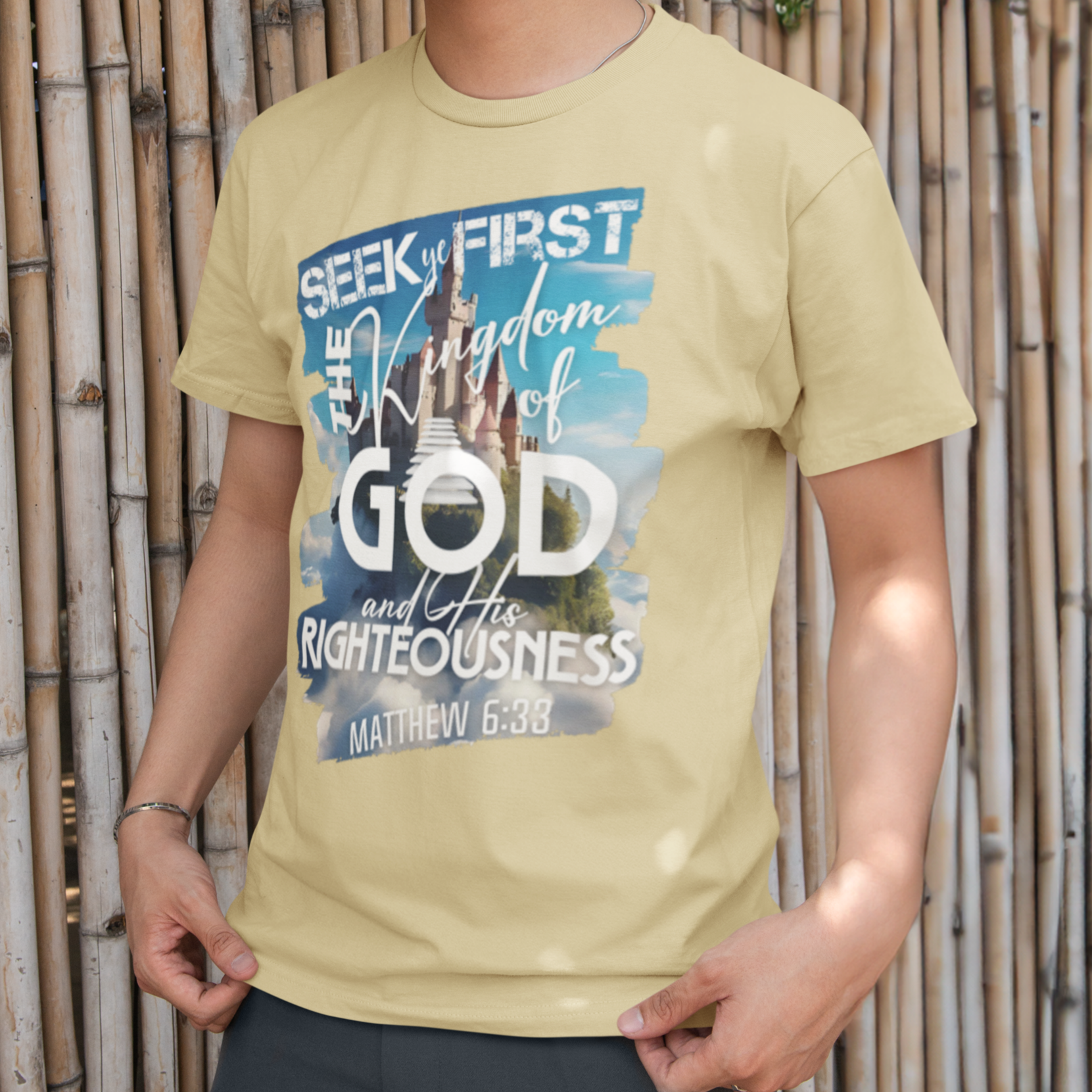 Person wearing a yellow t-shirt with a motivational quote against a bamboo background
