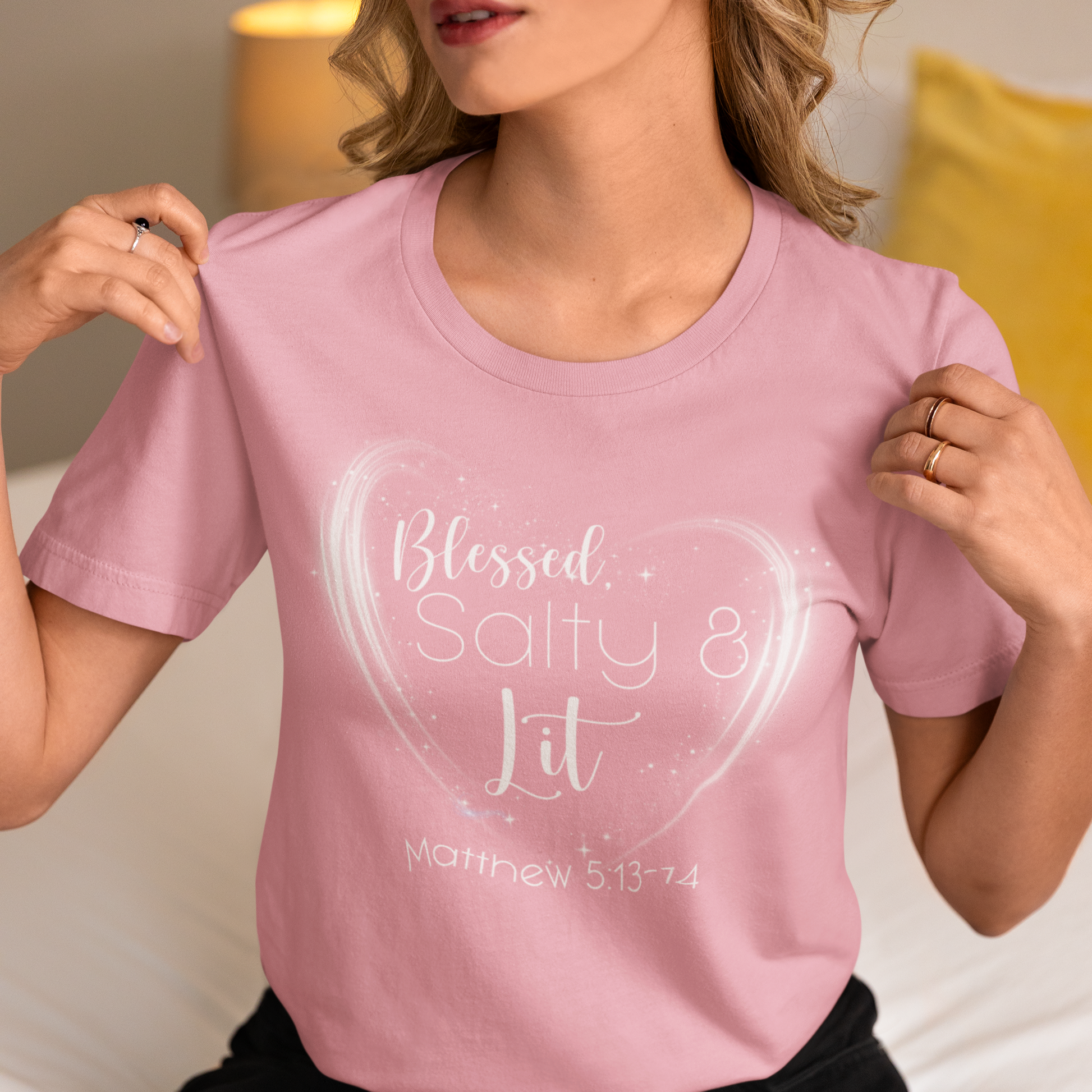 Person wearing a pink t-shirt with 'Blessed, Salty & Lit' text