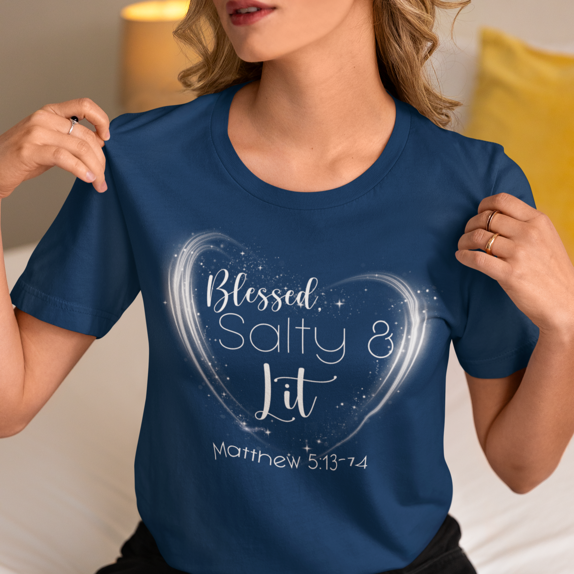 Person wearing a blue t-shirt with 'Blessed Salty & Lit' design