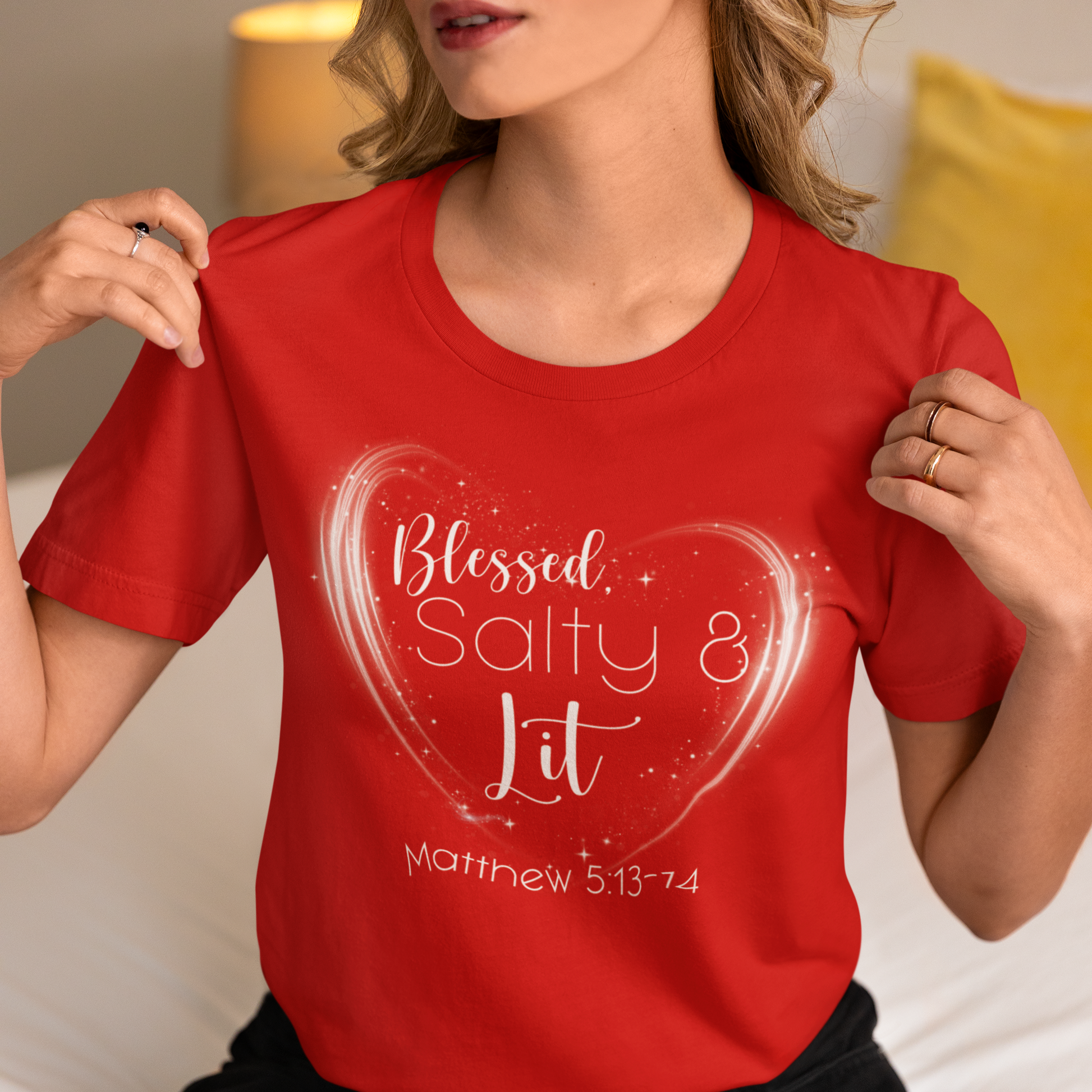 Person wearing a red t-shirt with a heart design and text.