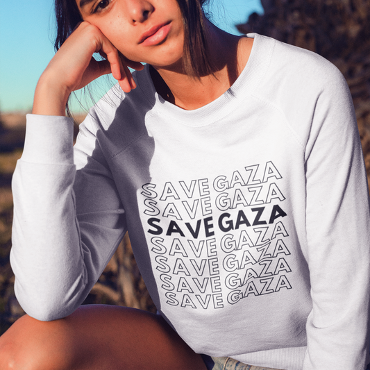 Person wearing a white sweatshirt with 'SAVE GAZA' text, sitting outdoors.