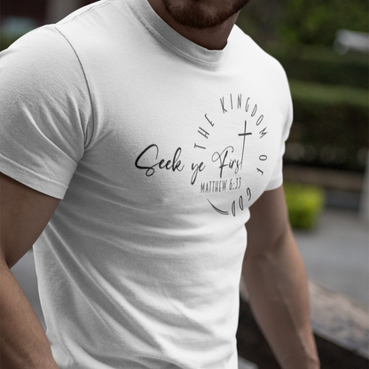 Person wearing a white t-shirt with text and design outdoors