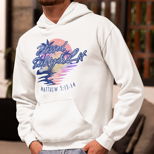Person wearing a white hoodie with colorful graphic and text, standing in an outdoor setting.