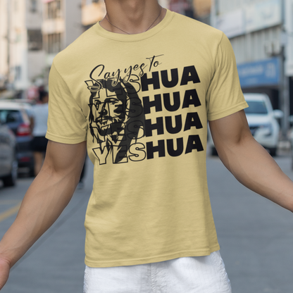 Person wearing a yellow t-shirt with text and graphics on a city street.