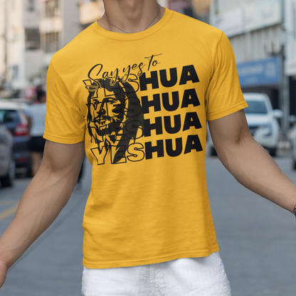 Person wearing a yellow t-shirt with text and graphics on a city street.