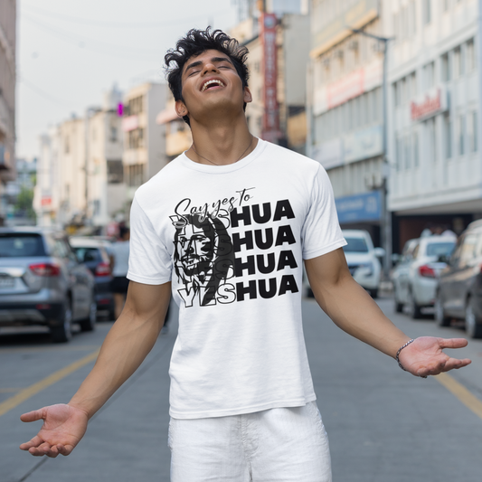 Person wearing a white t-shirt with black text and graphics on a city street.