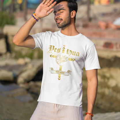 Man wearing a white t-shirt with gold text and design, standing outdoors with a colorful mural in the background.