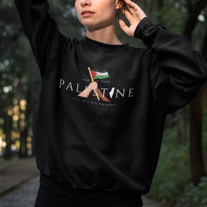 Person wearing a black sweatshirt with a design and text in a forest setting