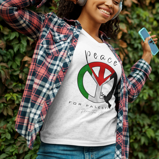 Woman wearing a white t-shirt with a peace symbol design, standing against a green leafy background.