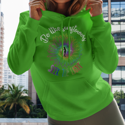 Woman wearing a bright green hoodie with text and graphics, standing in an urban setting.