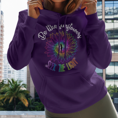 Woman wearing a purple hoodie with text and design, standing in an urban setting.