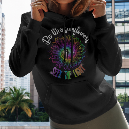 Woman wearing a hoodie with a colorful design in an urban setting