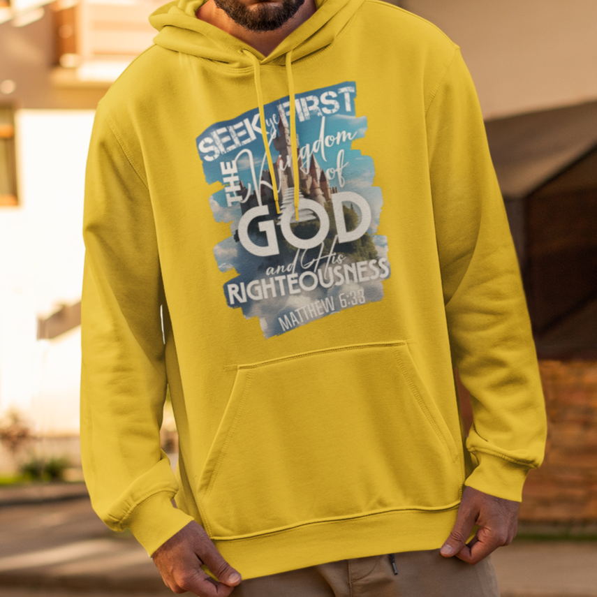 Man wearing a bright yellow hoodie with text, standing on a street.