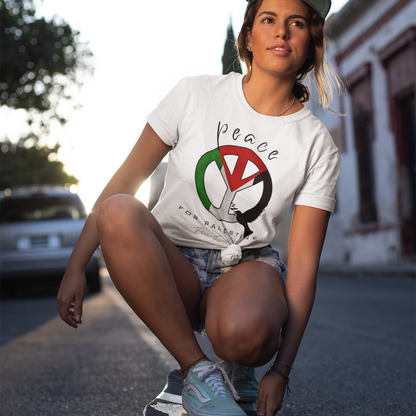 Person skateboarding on a street wearing a white t-shirt with a peace symbol design.