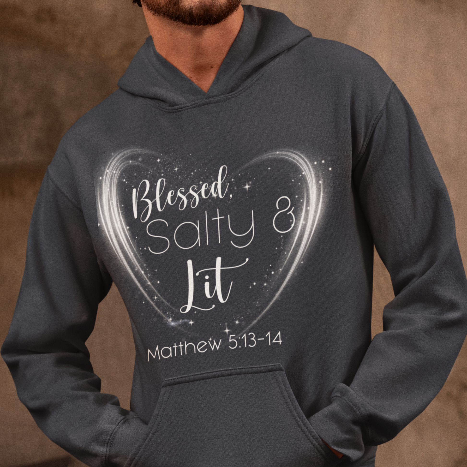 Person wearing a dark gray hoodie with a heart design and text on a brown background