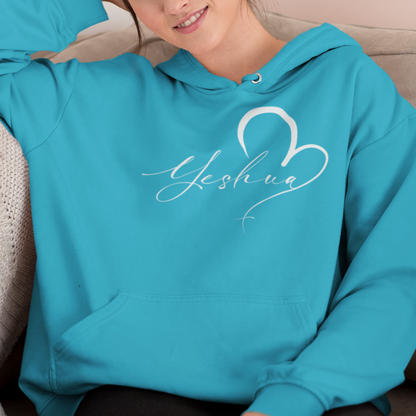 Woman wearing a turquoise hoodie with 'Yesenia' design, sitting on a couch.