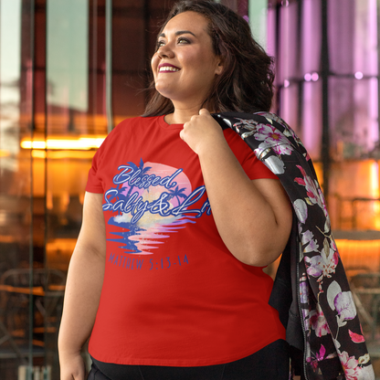 Woman wearing a red t-shirt with graphic design and black pants, standing in an urban setting.