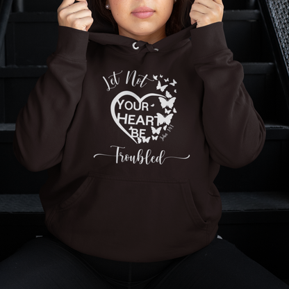 Person wearing a hoodie with text and butterfly design on stairs