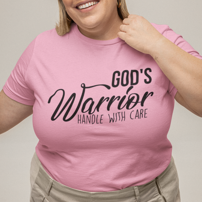 Person wearing a pink t-shirt with text, standing against a plain background