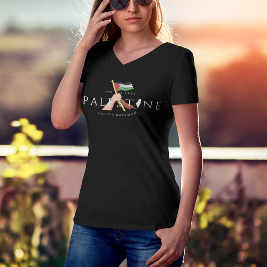 Woman wearing a black t-shirt with a graphic design, standing outdoors with a blurred background.