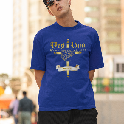 Man wearing a blue t-shirt with text and sunglasses, standing outdoors.