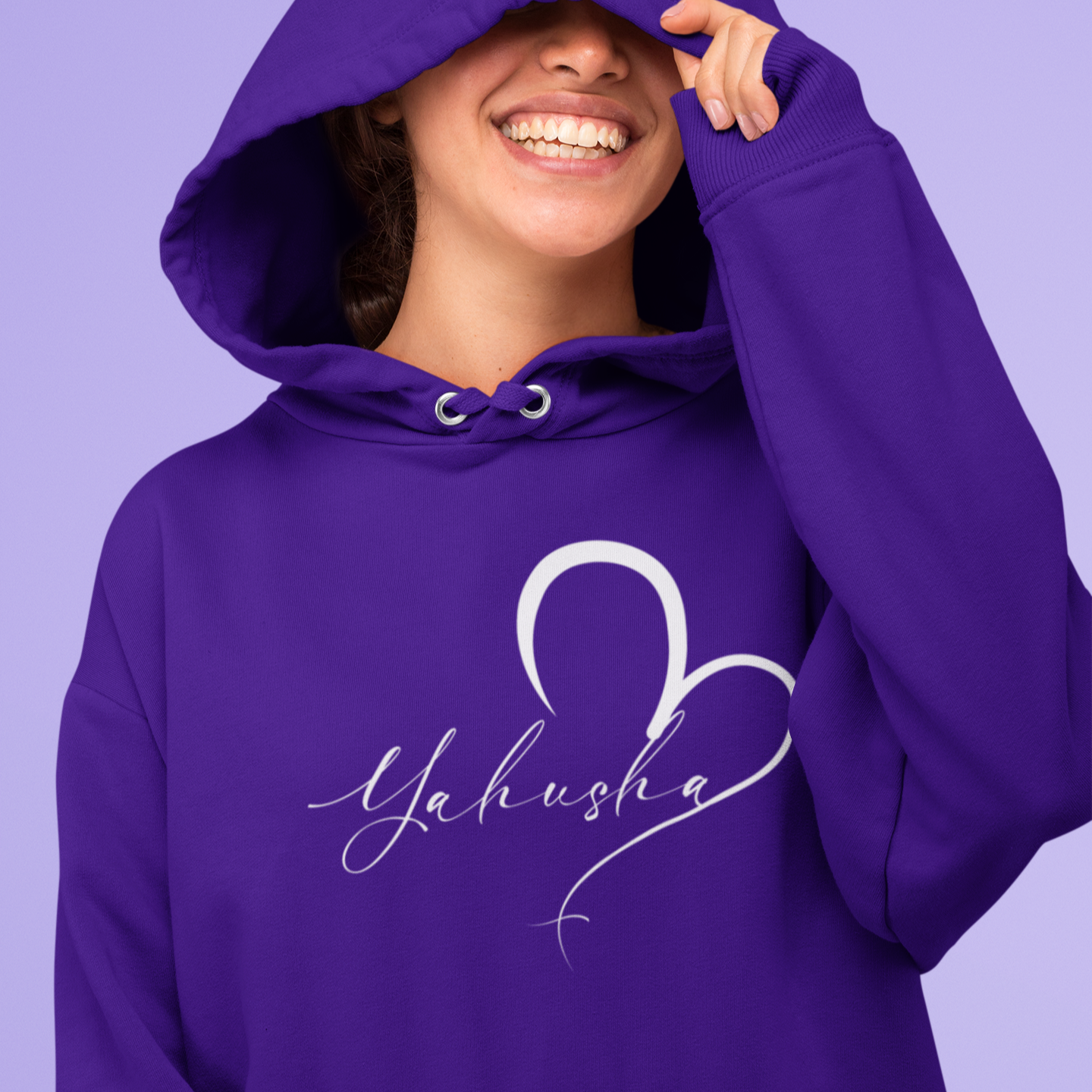 Person wearing a purple hoodie with 'Yahusha' design on a purple background