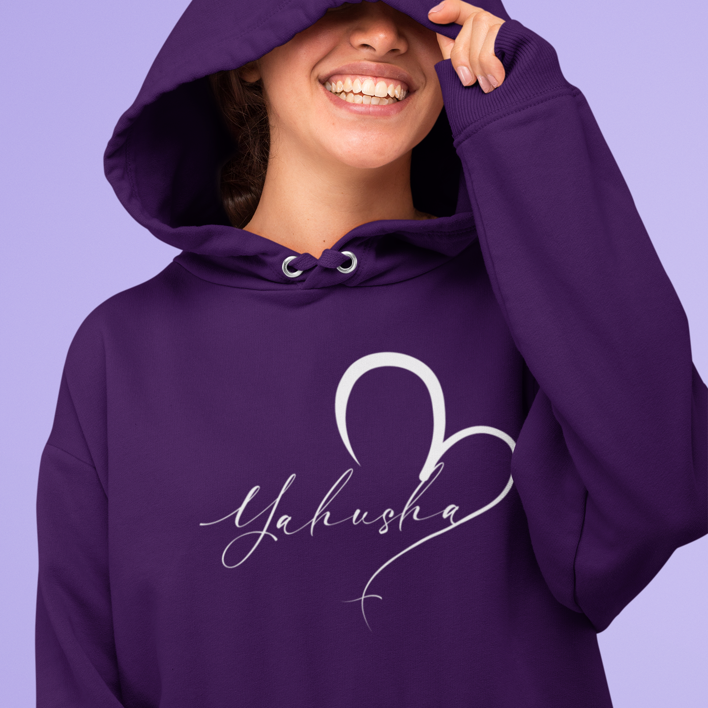 Person wearing a purple hoodie with 'Yahusha' design on a purple background