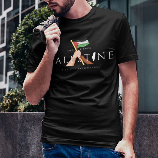 Man wearing a black t-shirt with a logo and text, standing in an urban setting.