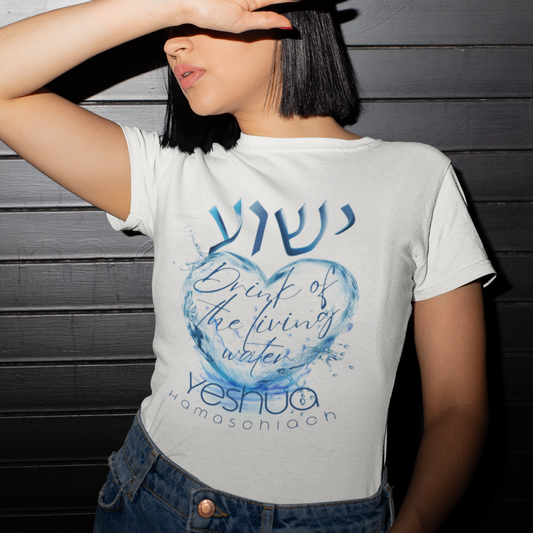 Person wearing a white t-shirt with a blue design and text against a dark wooden background