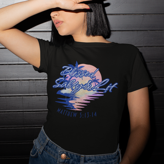 Person wearing a black t-shirt with a colorful design and text against a dark wooden background