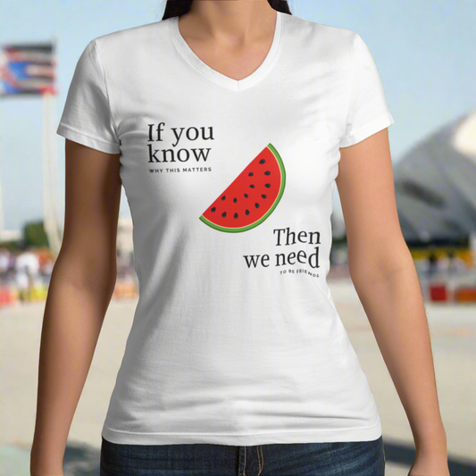 Person wearing a white t-shirt with a watermelon graphic and text on a light green background