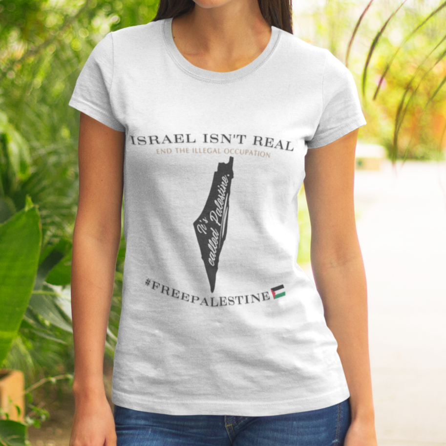 Woman wearing a t-shirt with 'Israel isn't real' and '#FreePalestine' text in a tropical setting.